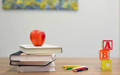 apple on books and letter blocks - values based education